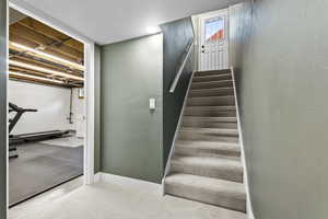 Stairs with baseboards and carpet floors