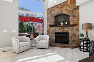 Living room with a high ceiling and a fireplace