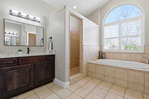 Full bathroom with vanity, a bath, walk in shower, and light tile patterned floors