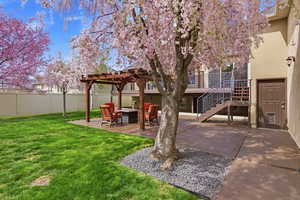 Fenced yard featuring a patio area, a fire pit, and a pergola
