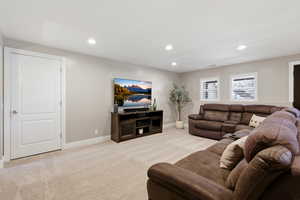 Living room with light colored carpet and recessed lighting
