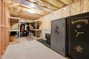 Unfinished below grade area with a desk