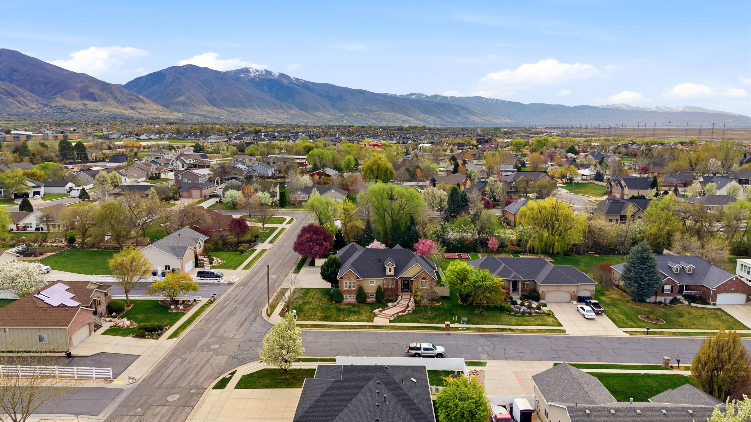 Aerial perspective of suburban area featuring a mountainous background