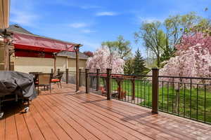 Wooden deck featuring outdoor dining space and a yard