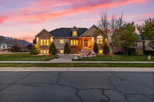 Traditional home featuring stone siding and a yard