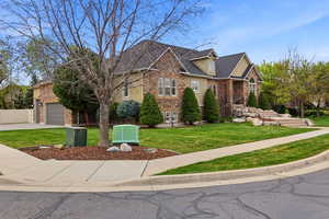 View of front of house with driveway, stucco siding, stone siding, an attached garage, and a shingled roof