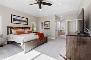 Bedroom featuring light colored carpet, ensuite bathroom, ceiling fan, and recessed lighting