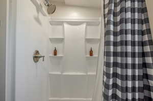 Full bathroom featuring a stall shower