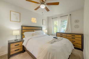 Bedroom featuring light carpet and a ceiling fan