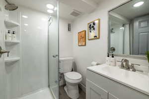 Bathroom with a stall shower and vanity