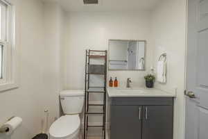 Half bathroom featuring toilet and vanity