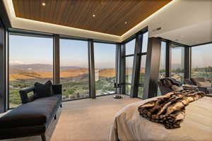 Carpeted bedroom with expansive windows, a mountain view, recessed lighting, and wooden ceiling