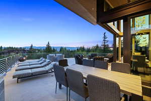 Patio terrace at dusk with a patio area, a mountain view, and outdoor lounge area
