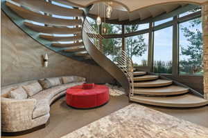 Stairs featuring suspended lighting and a high ceiling