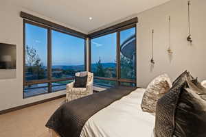 Carpeted bedroom featuring a mountain view and baseboards