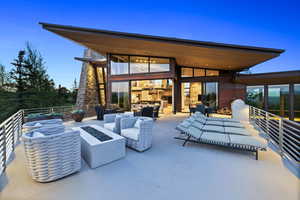 View of patio with an outdoor living space with a fire pit