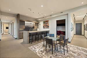 Dining space featuring light colored carpet and recessed lighting