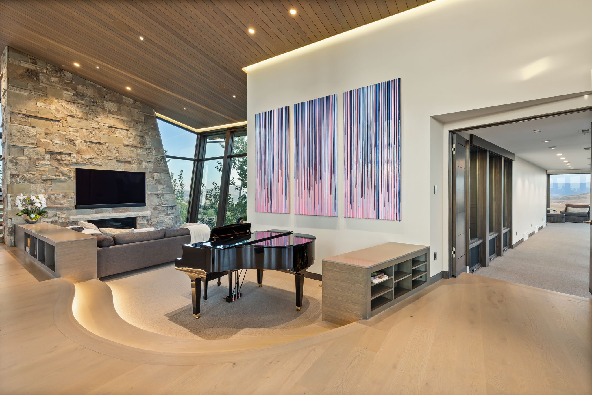 Living area featuring light wood-type flooring, expansive windows, recessed lighting, and a high wooden ceiling