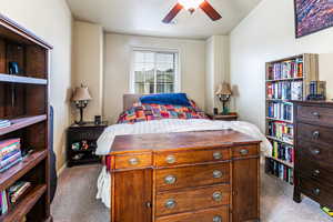 Bedroom with ceiling fan and carpet