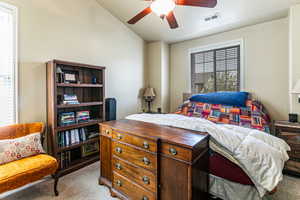 Bedroom featuring light carpet and a ceiling fan