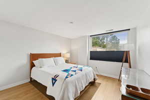 Bedroom featuring light wood-style flooring and baseboards