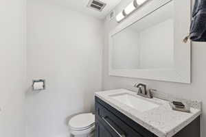 Half bath with vanity and toilet
