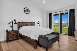 Spacious room featuring light wood-finish flooring, white walls, and a recessed ceiling light