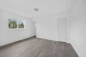 Spare room with wood finished floors and baseboards