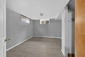 Below grade area featuring light wood-style flooring and baseboards