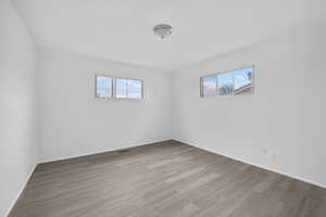 Unfurnished room with light wood-style flooring and healthy amount of natural light