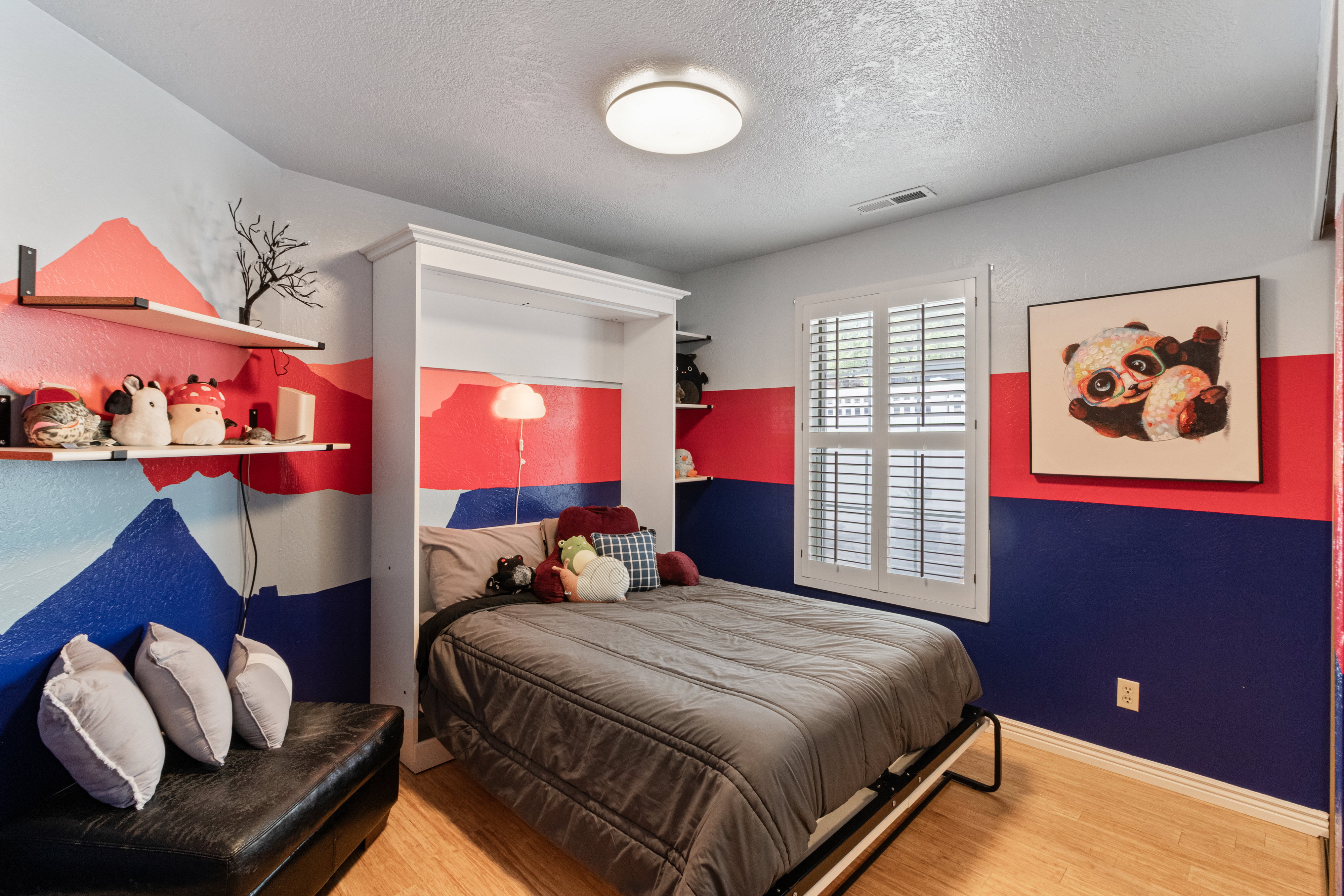 Bedroom with wood finished floors and a textured ceiling