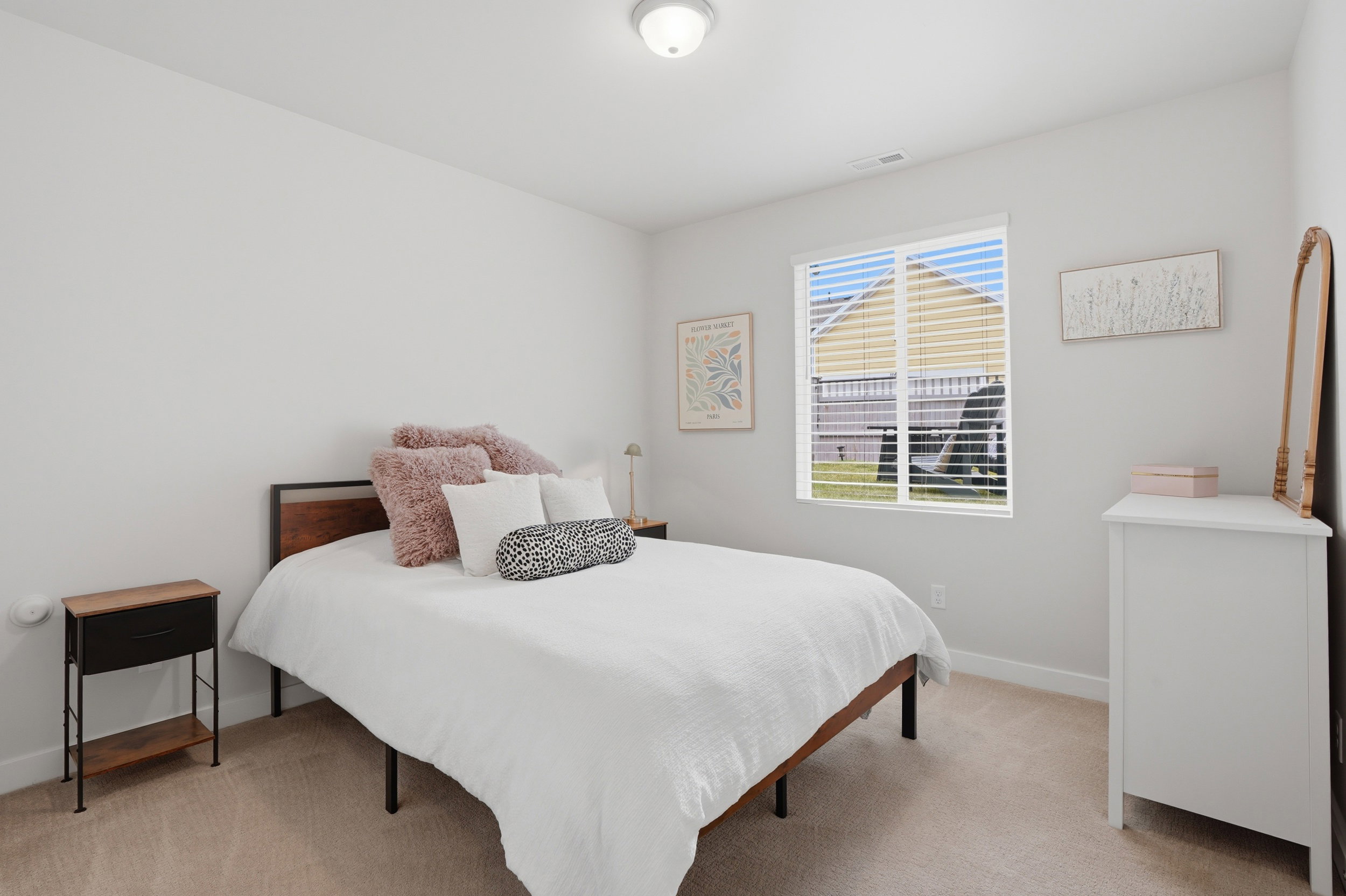 Bedroom with baseboards and light colored carpet