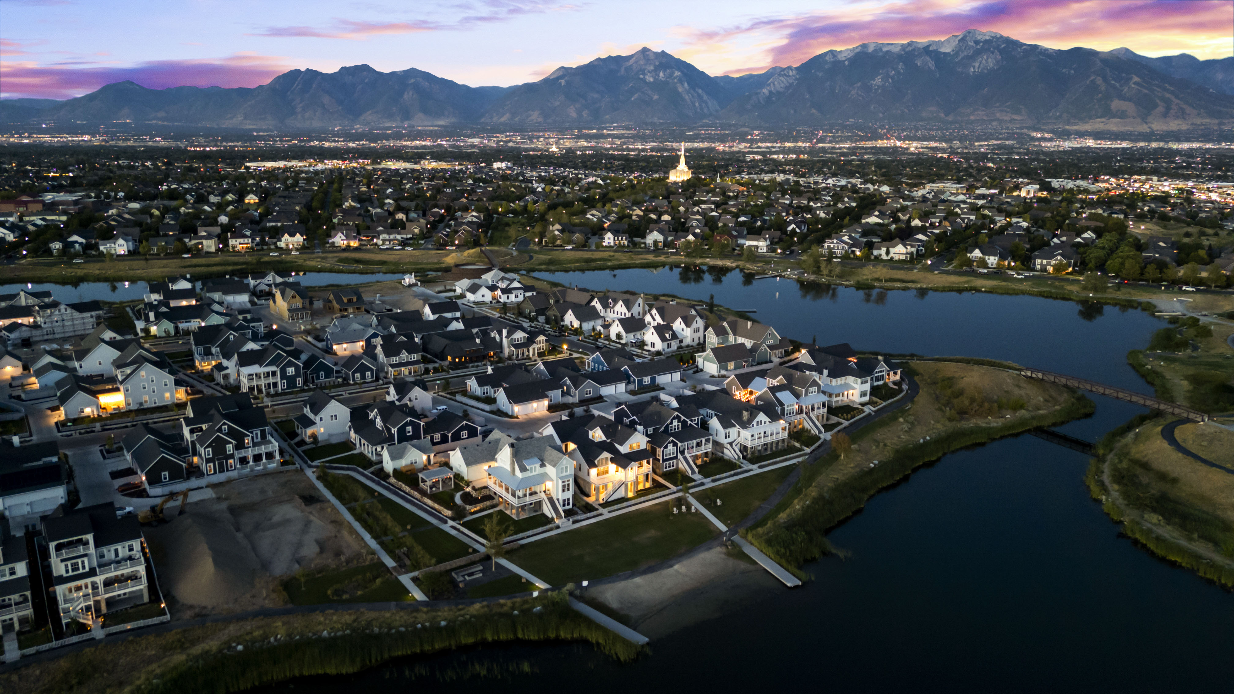 Aerial view at dusk of a residential view and a water and mountain view