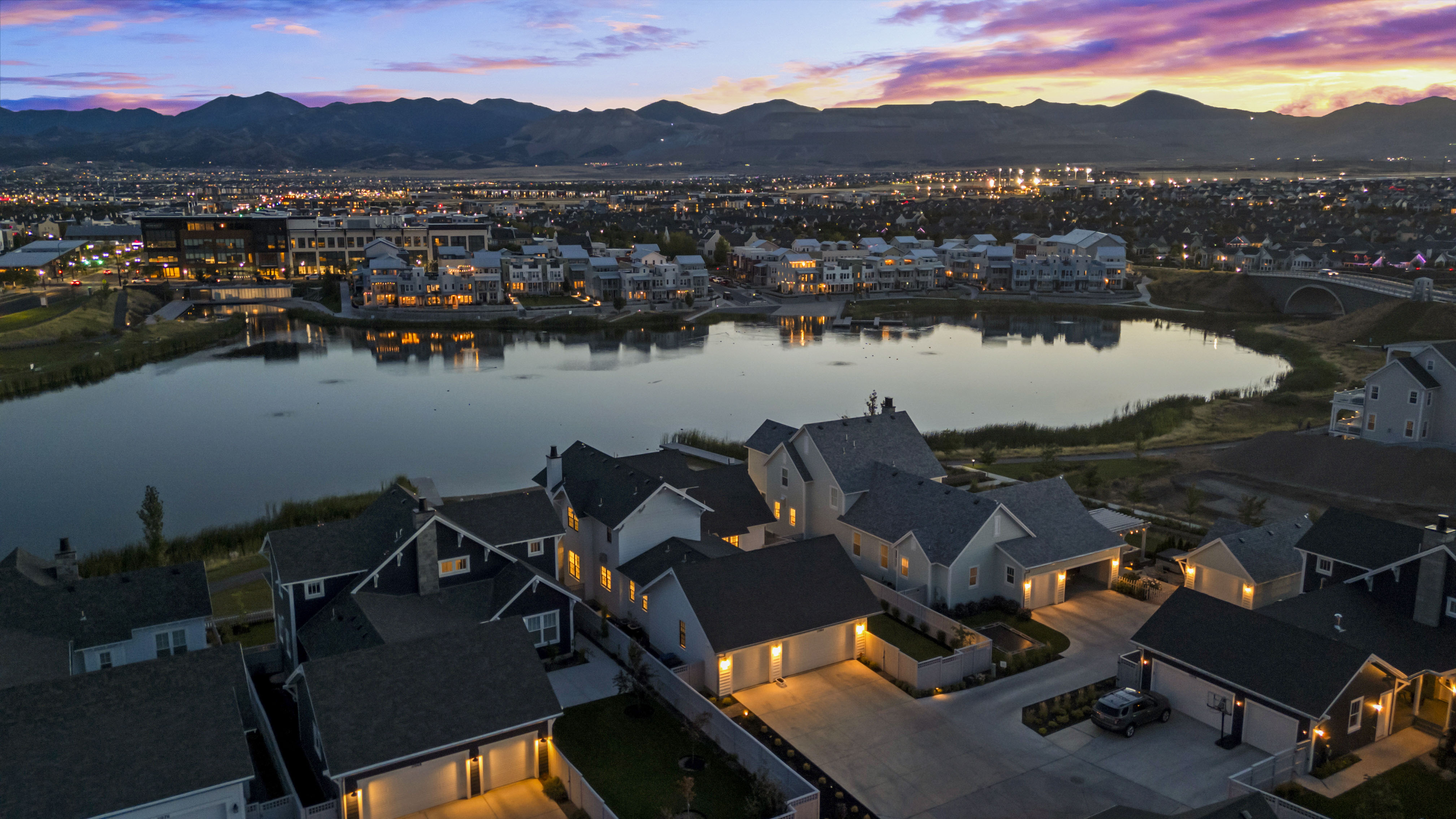 Aerial view at dusk of a residential view and a water and mountain view