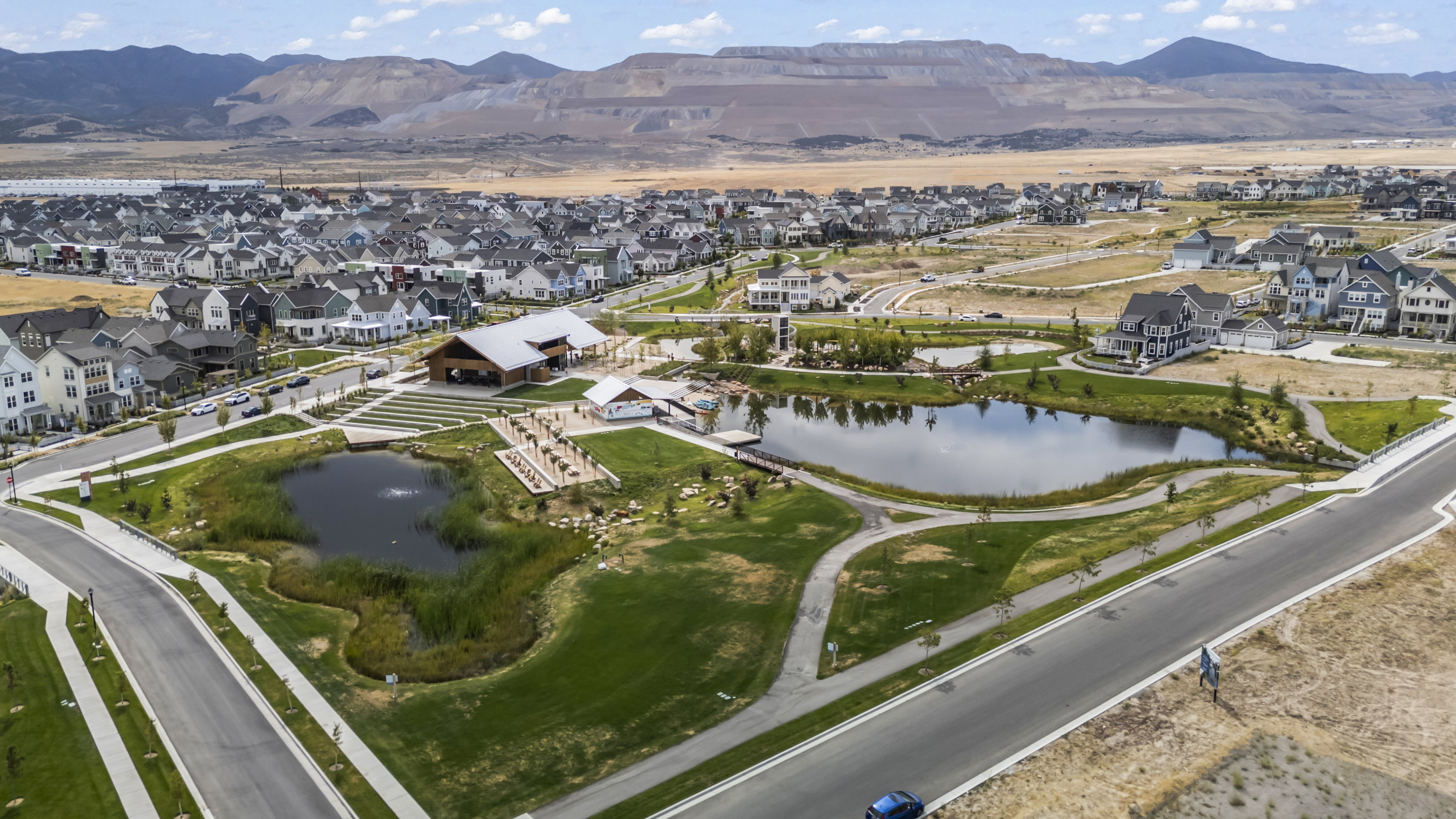 Aerial view of property's location with nearby suburban area and a water and mountain view