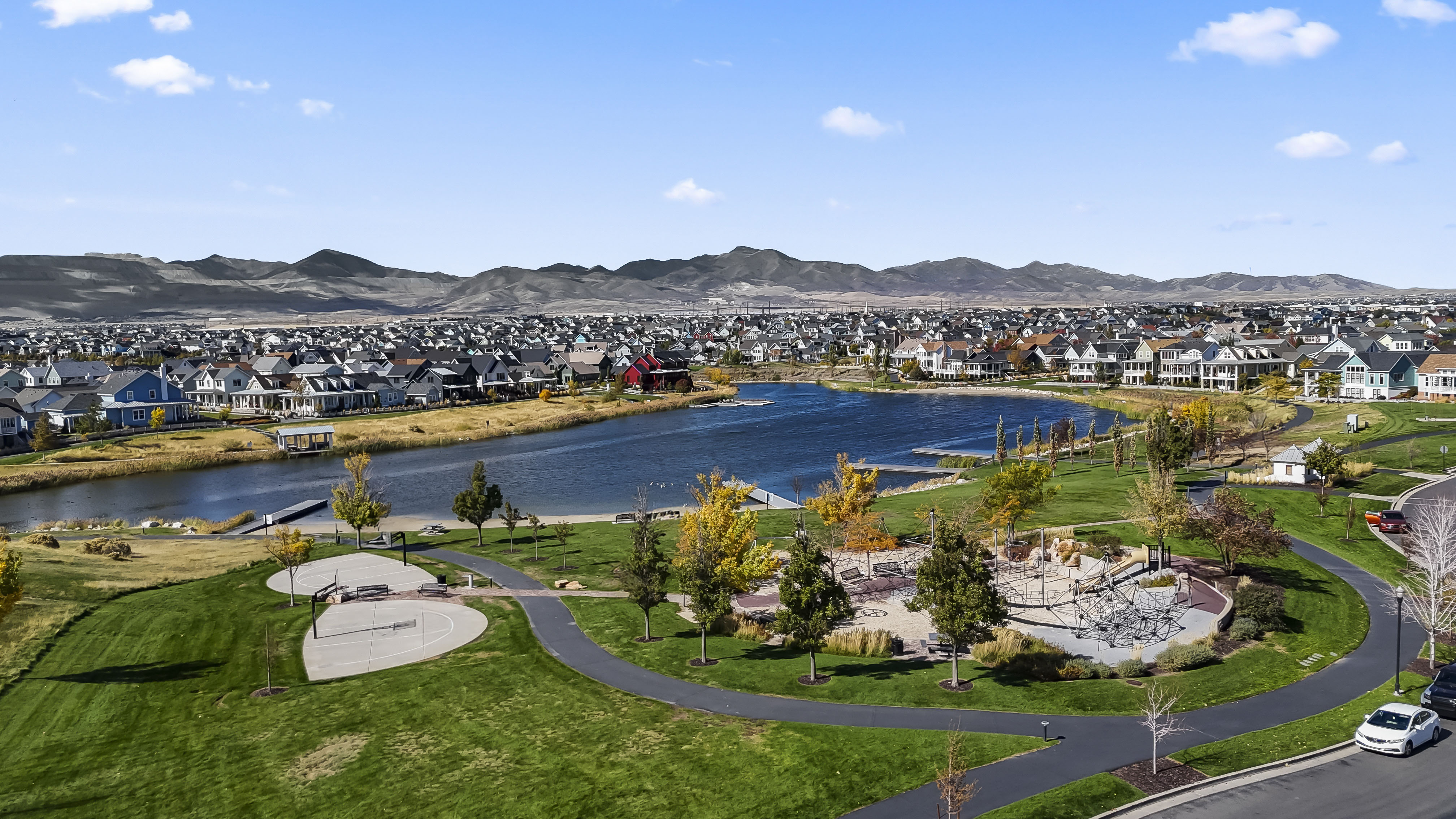 Water view with nearby suburban area and a mountainous background