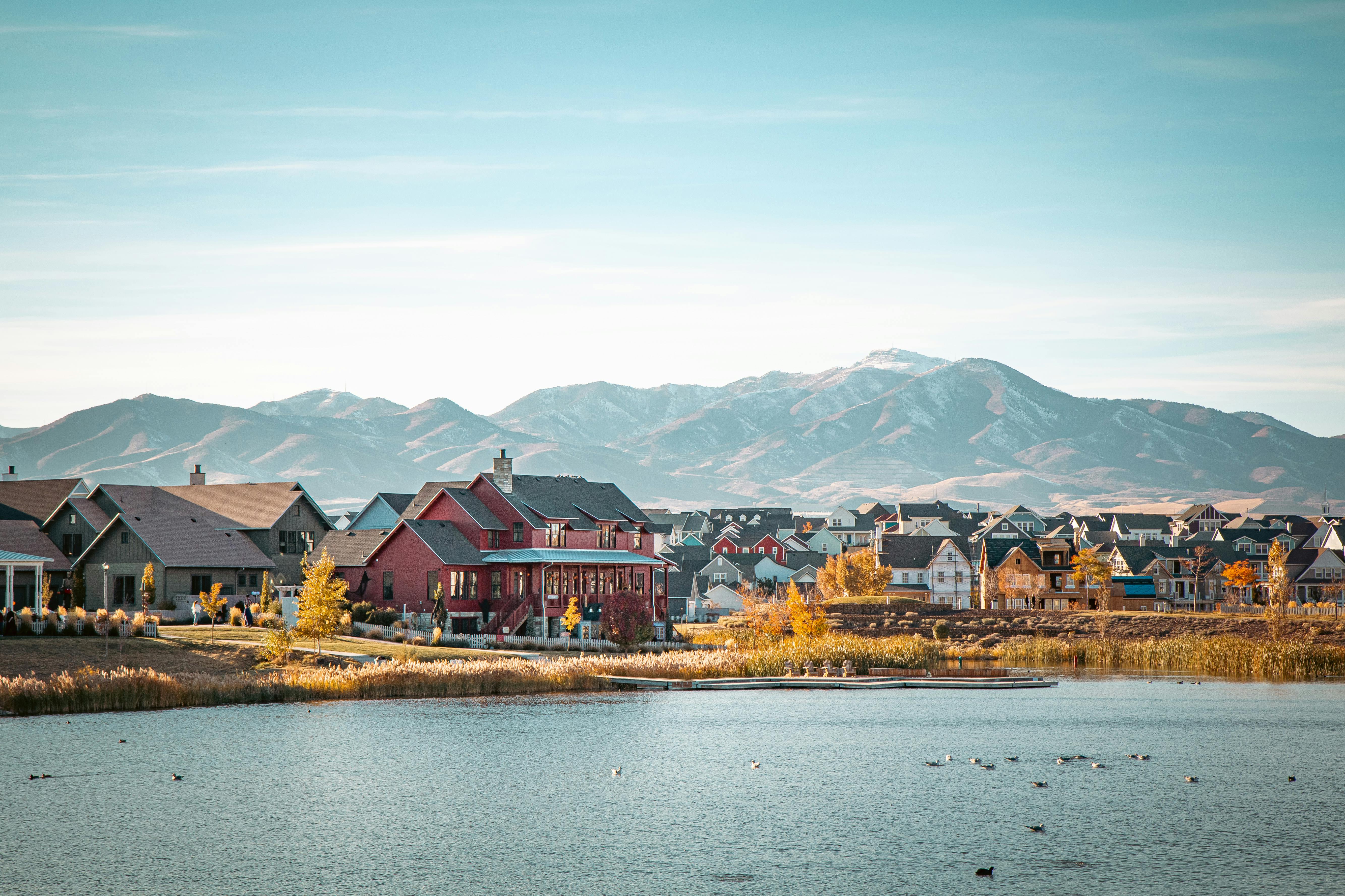 Water view with a mountainous background and nearby suburban area