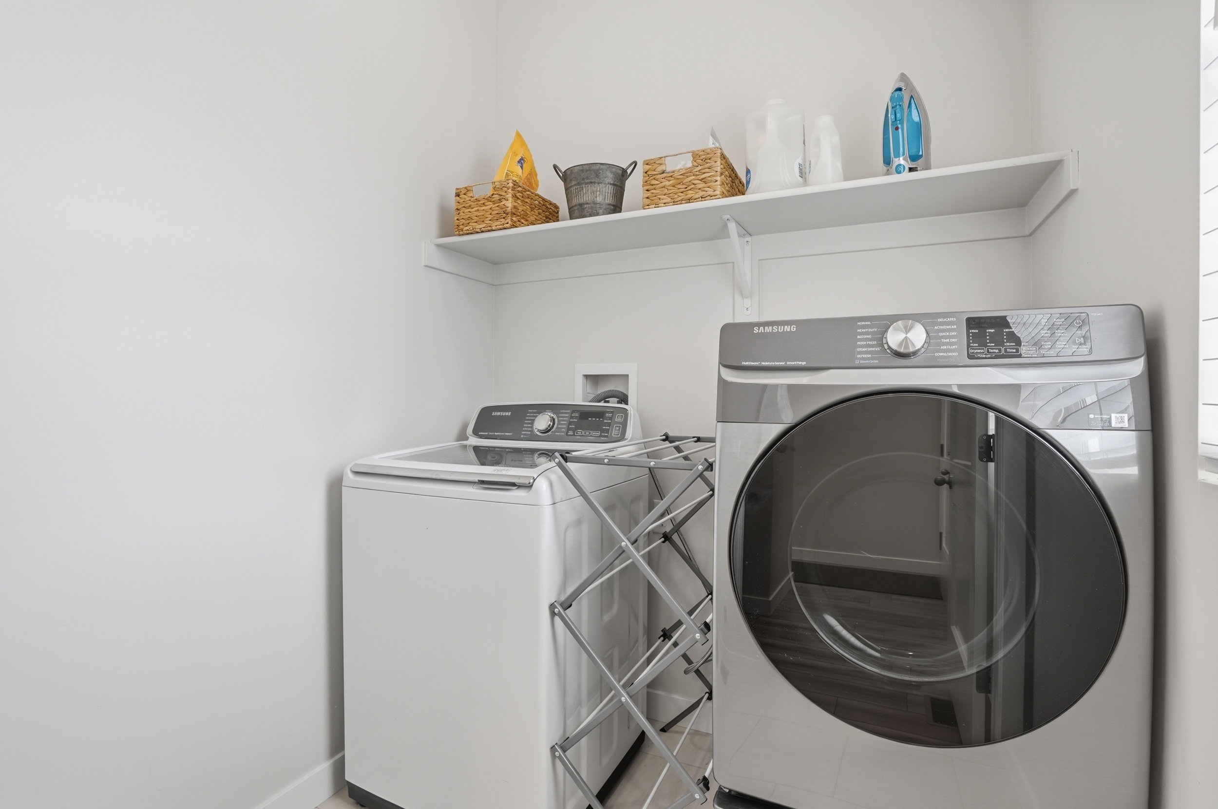 Laundry area with washing machine and dryer and baseboards