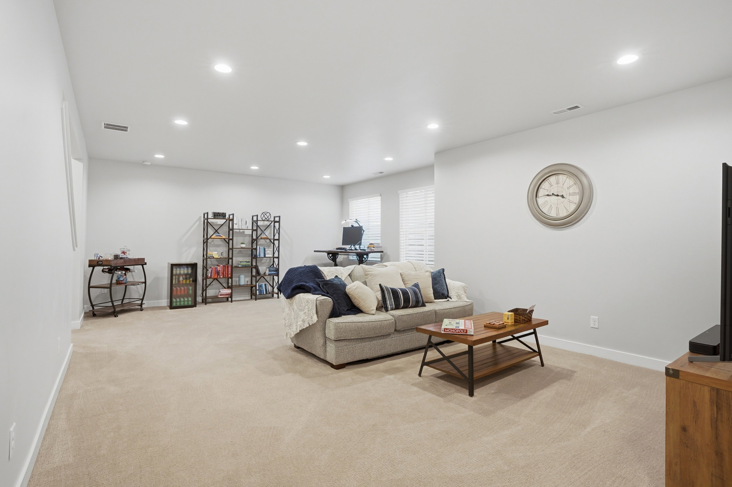 Living area featuring light colored carpet and recessed lighting