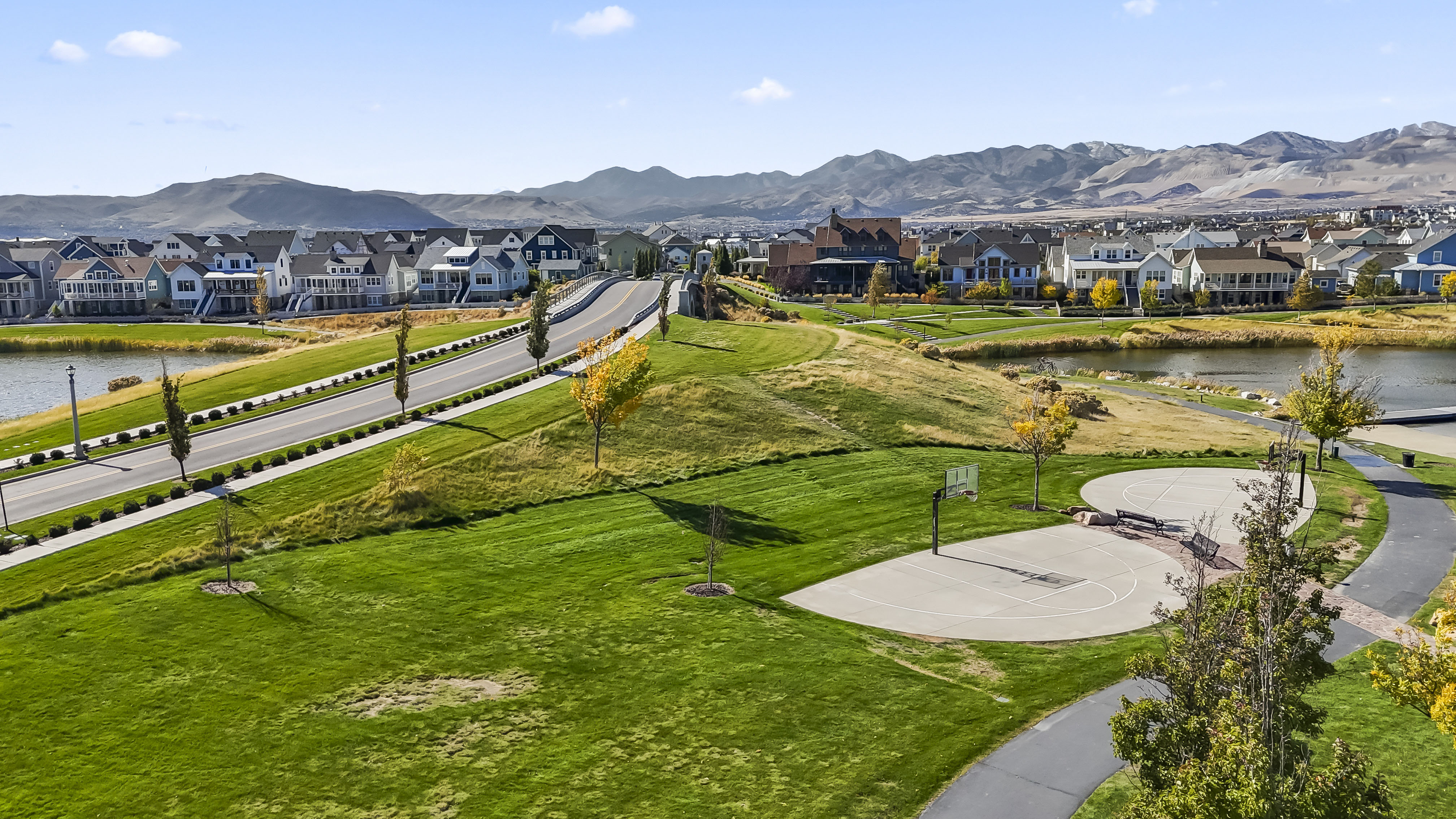 View of property's community featuring a water and mountain view, community basketball court, and a residential view