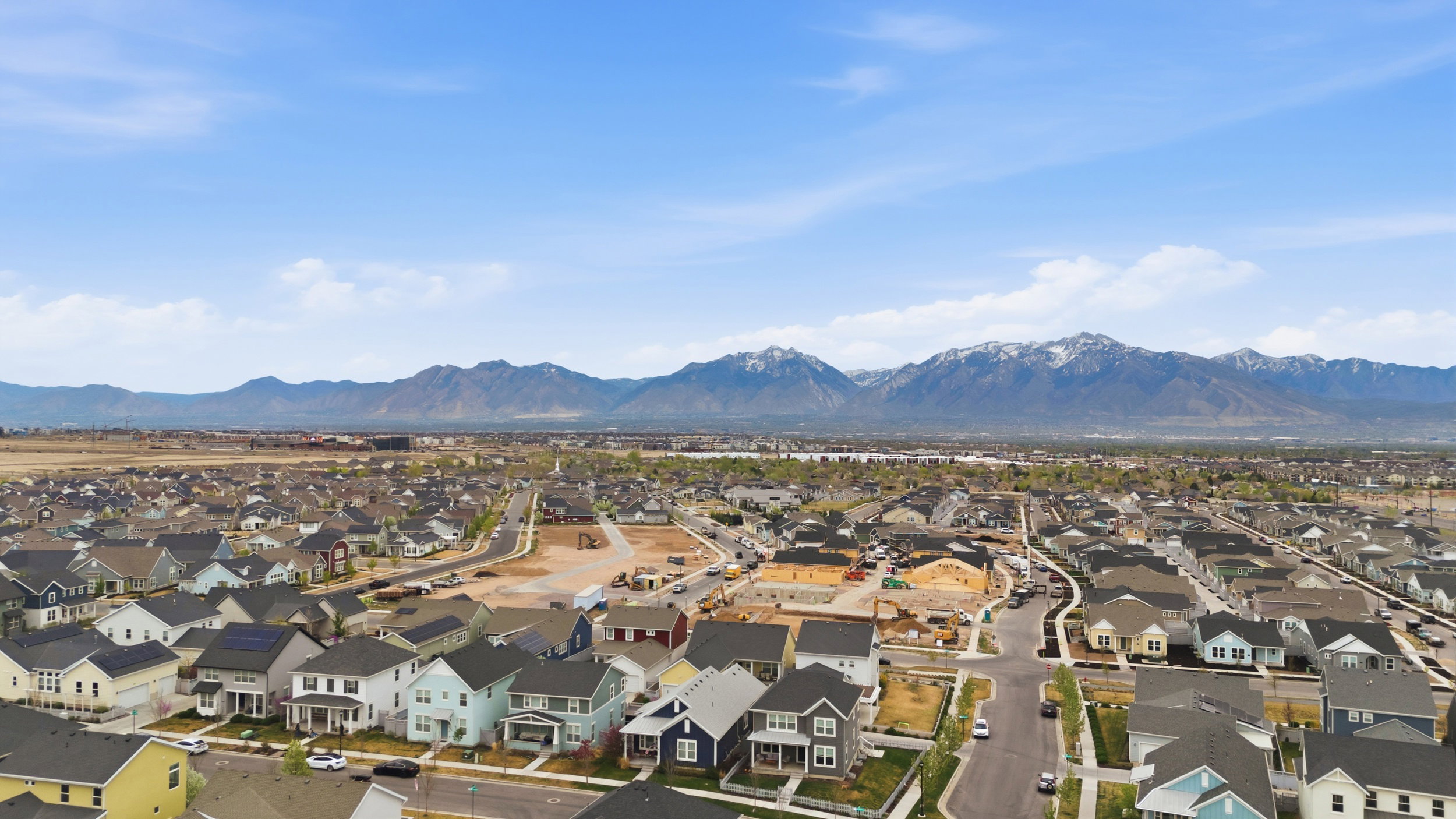 Aerial perspective of suburban area with a mountain backdrop