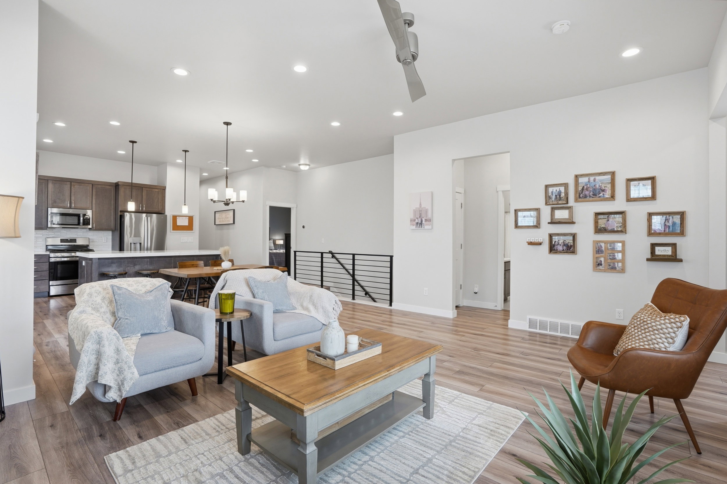 Living room featuring light wood finished floors and suspended lighting
