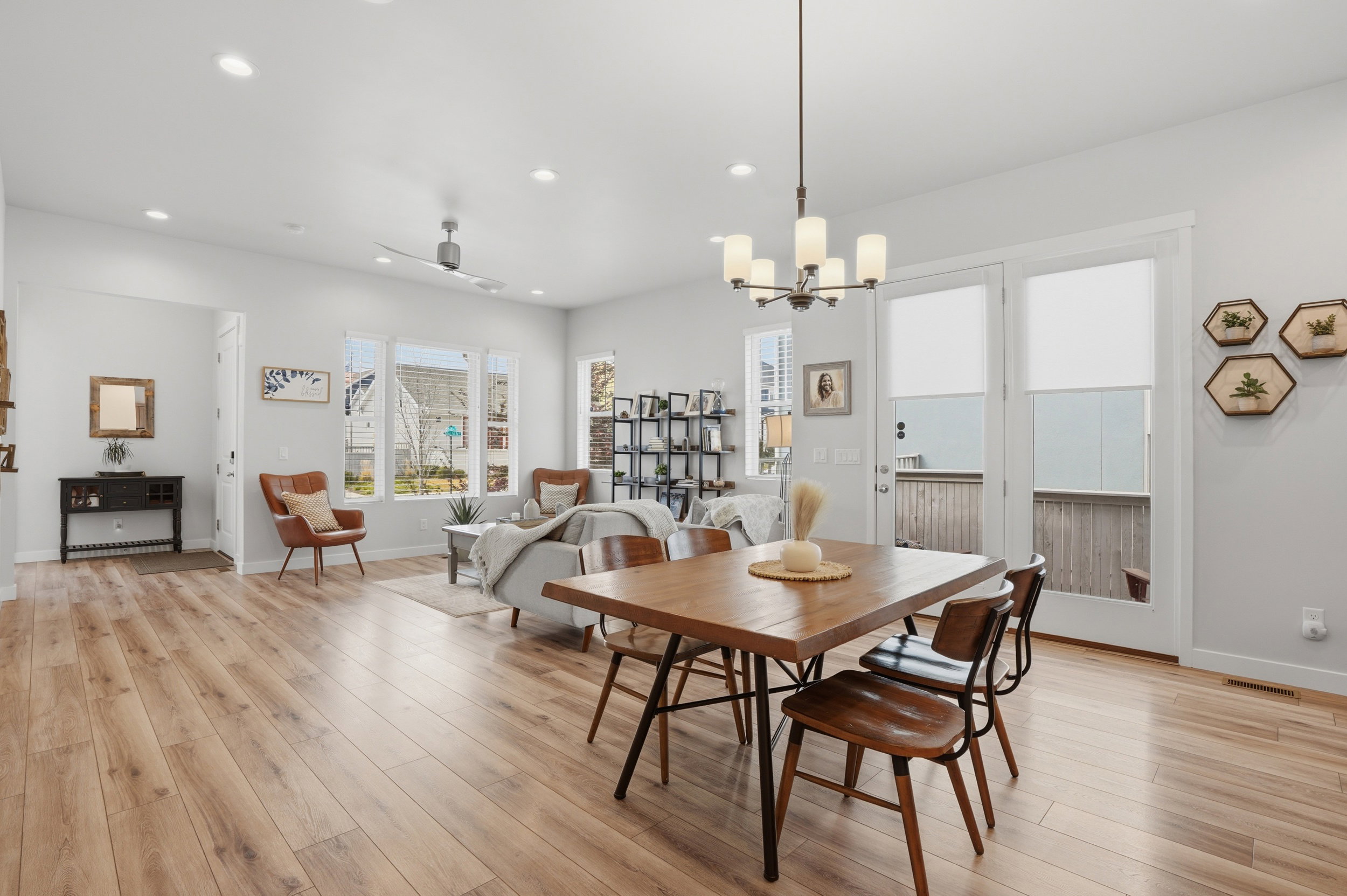 Dining room featuring light wood-style floors, ceiling fan, and hanging lights