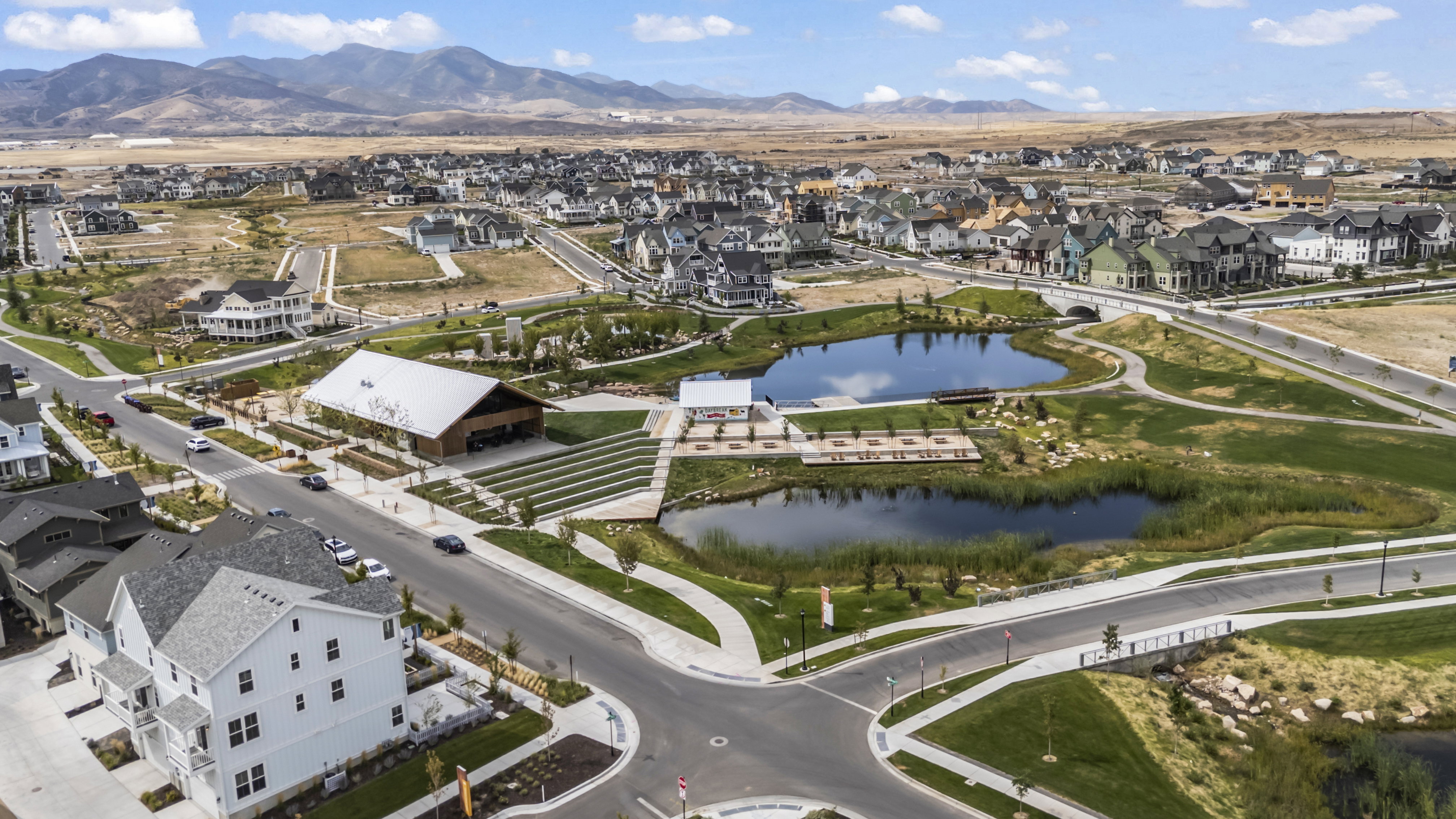 Aerial overview of property's location with nearby suburban area and a water and mountain view