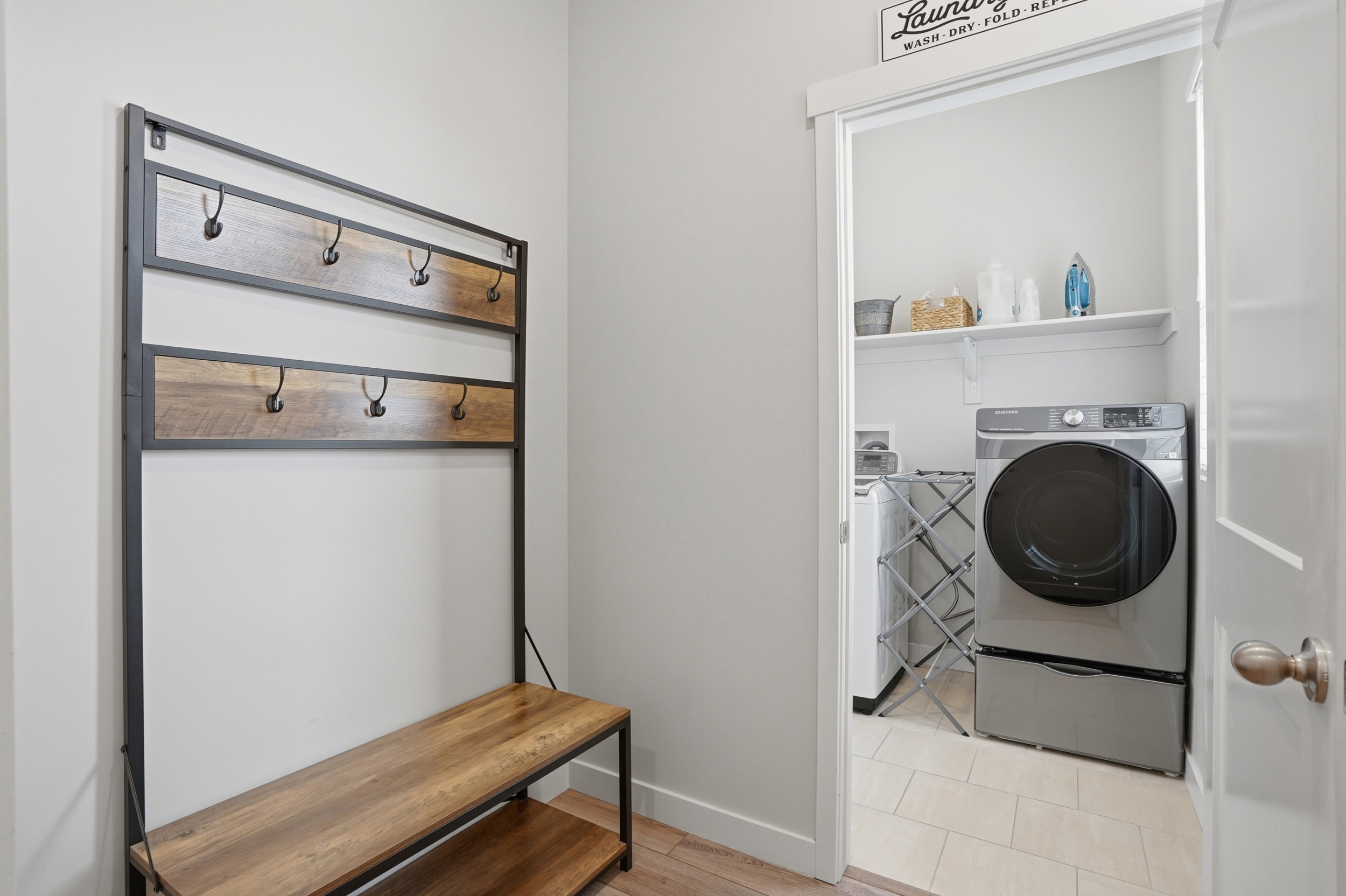 Laundry room with independent washer and dryer and light wood finished floors