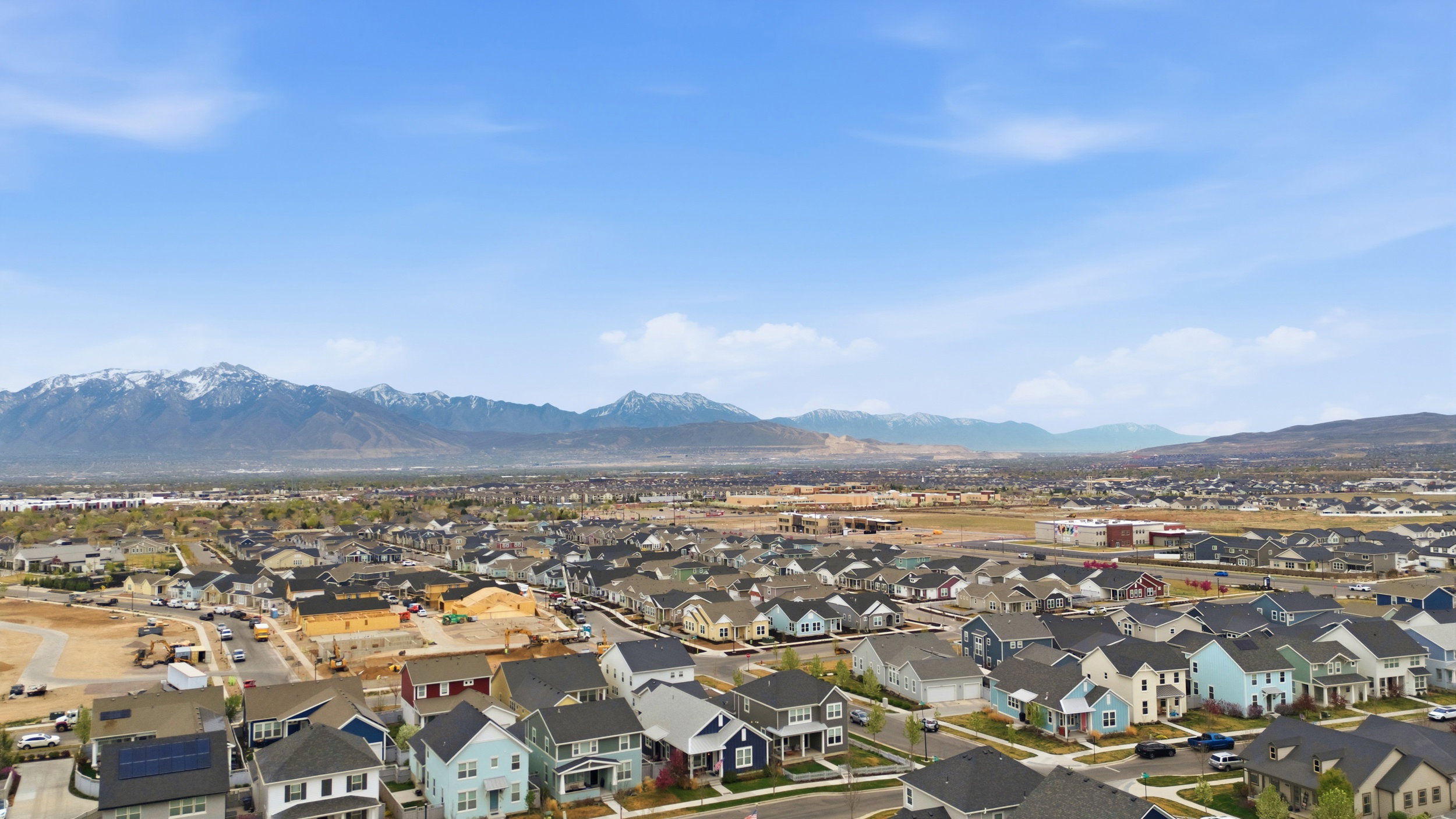 Aerial perspective of suburban area featuring a mountain backdrop