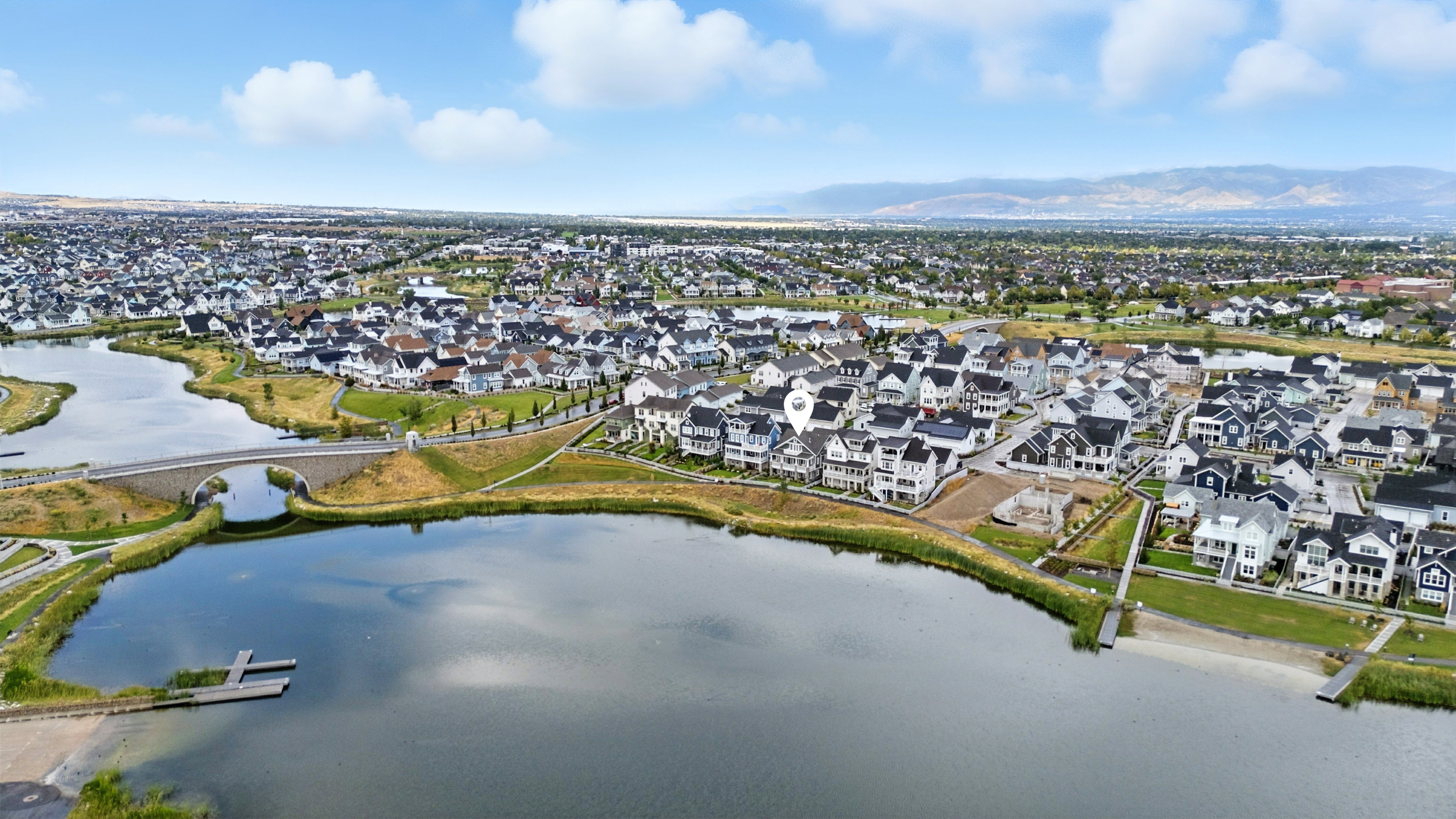 Aerial view of residential area featuring a nearby body of water