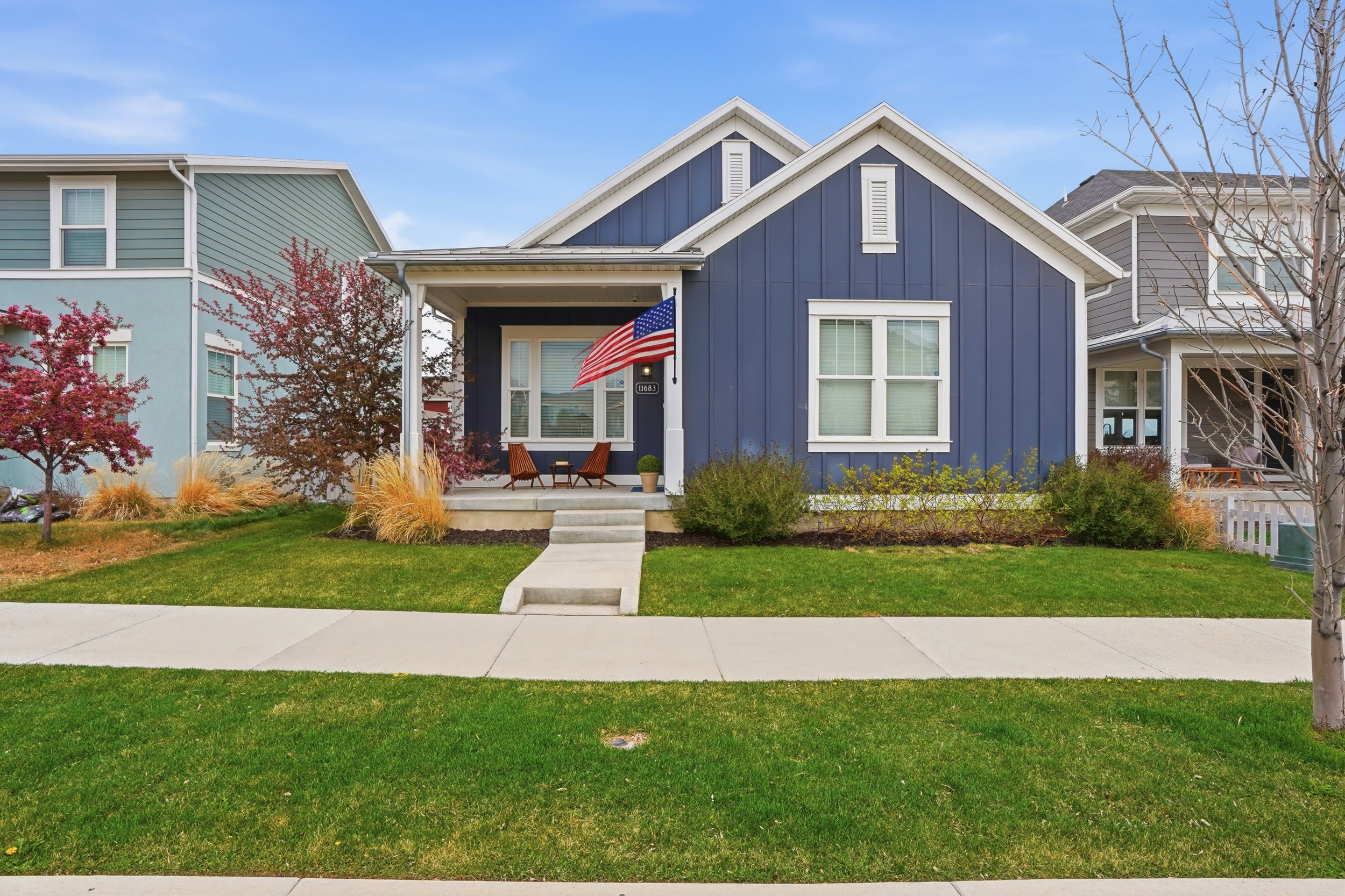 View of front of property featuring board and batten siding, a porch, and a front lawn