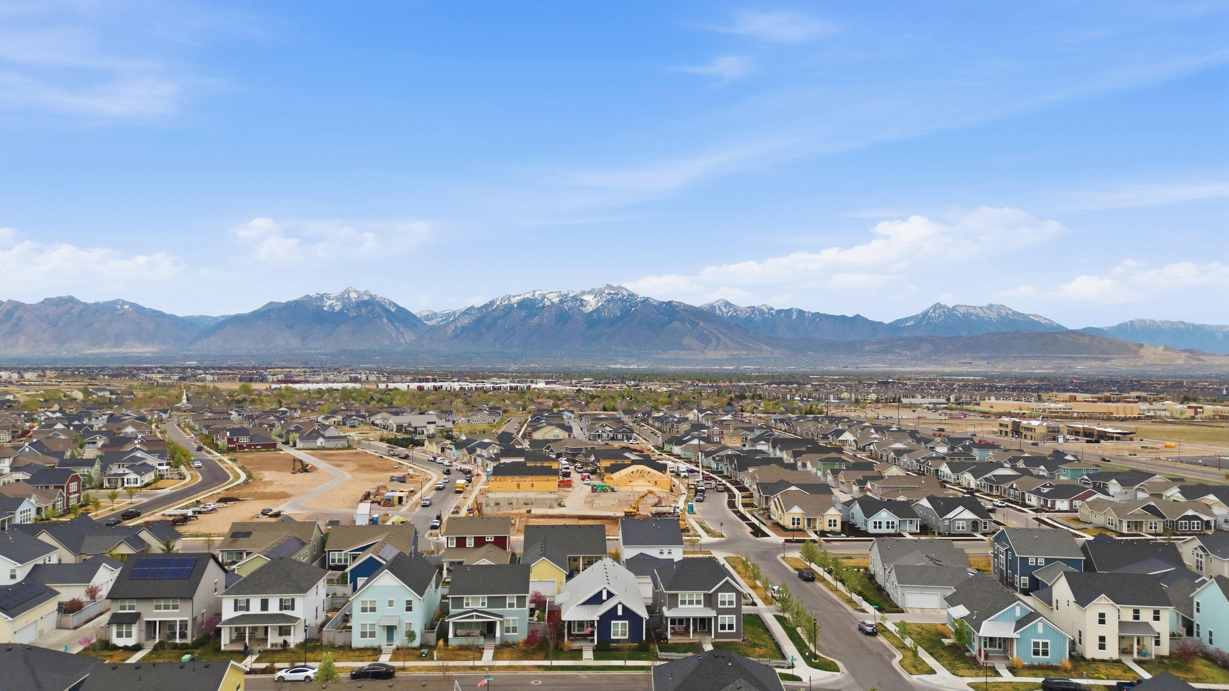 Aerial perspective of suburban area featuring a mountainous background