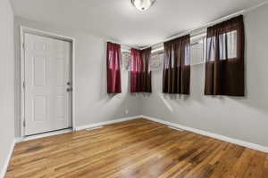 Spare room with light wood finished floors and healthy amount of natural light